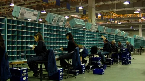 Postal Service Staff Sorting Letters and Parcels on Shelves   動画素材 154877912