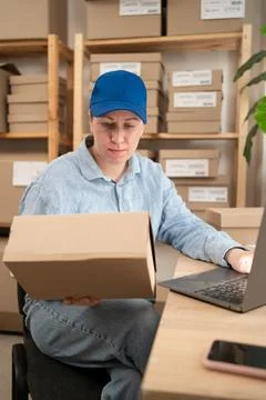 Postal Worker Checking Shipping Address On Parcel Stock Photos