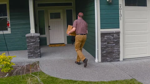 Postal worker delivering package while practicing social distancing Stock Footage 246160750