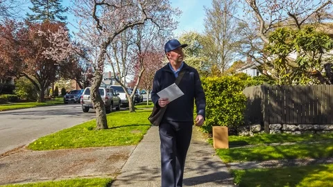 Postal worker hand delivering mail 動画素材 128602841