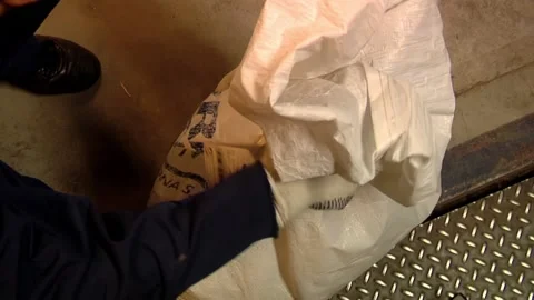 Postal Worker Sealing Mail Bag with Security Plastic Tie at Sorting Center   Stock Footage 154876642