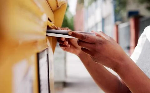 The Postal Worker's Hand Delivering A Full Mailbox Of Letters. A Young Busine Stock Photos