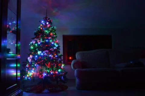 Postcard with a Christmas tree in a window with colored lights. Postcard wit Stock Photos