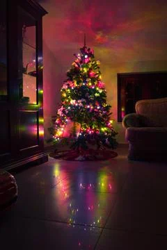 Postcard with a Christmas tree in a window with colored lights. Postcard wit Stock Photos