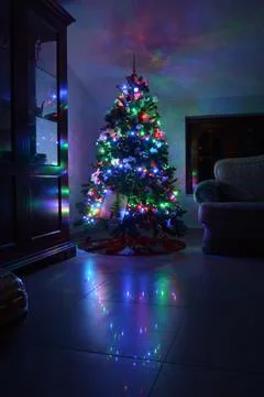 Postcard with a Christmas tree in a window with colored lights. Postcard wit Stock Photos