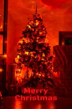 Postcard with a Christmas tree in a window with red lights and the inscriptio Foto stock
