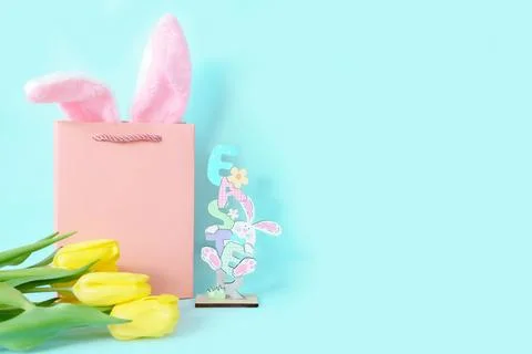 Postcard for Easter with a place for text. On a blue background, rabbit ears in Stock-Fotos