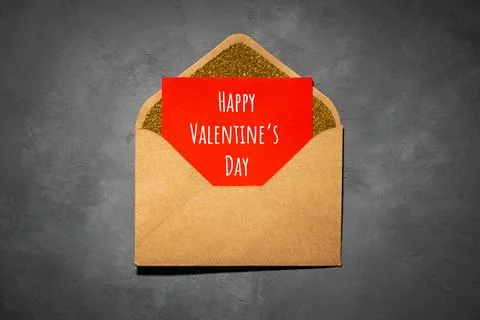 Postcard, envelope with paper inside, with the text happy valentines day, on  库存照片