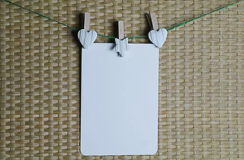 Postcard hangs on clothespins on a string, for mockup Foto stock