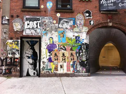 Poster covered wall in NYC Fotos de archivo
