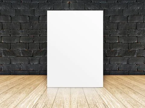 Poster frame at black brick wall and wooden floor Stock Photos
