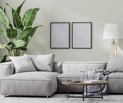 Poster frames mock up in modern room with gray sofa and coffee table and t... Foto stock