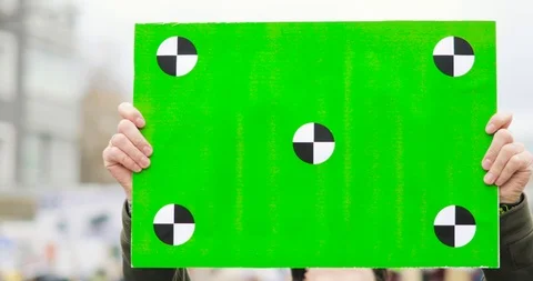 Poster with green screen in man's hands on the street. Video stock 107597084