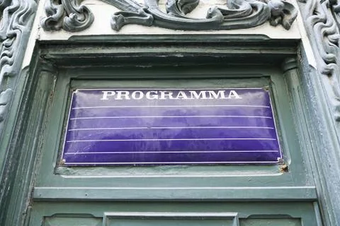 Poster program on a wall, detail of an old empty billboard on a street Stock Photos