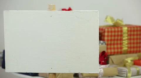 Poster on stick on the background of gift boxes with bows Stock Footage 57937900