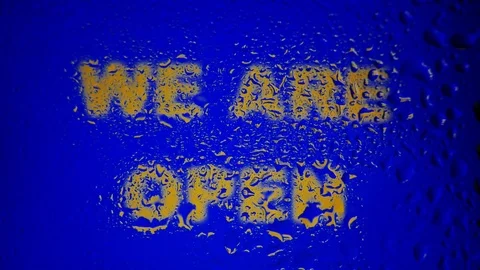 A poster with the text "WE ARE OPEN" covered by raindrops Stock Footage 80809446
