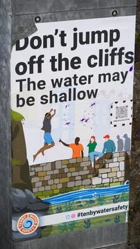 Poster warning tourists not to jump off cliff because of shallow water Stock Photos
