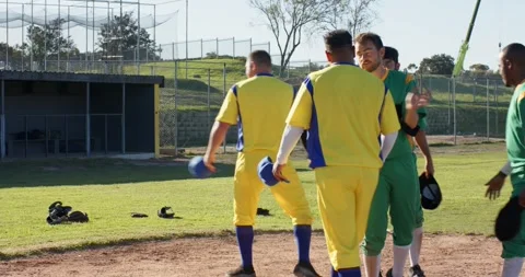 Postgame handshake sparking opponents cap saluting on field, escorting injured Stock Footage 338433976