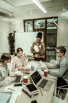 Postgraduate students using laptops preparing for brainstorming Stock Photos