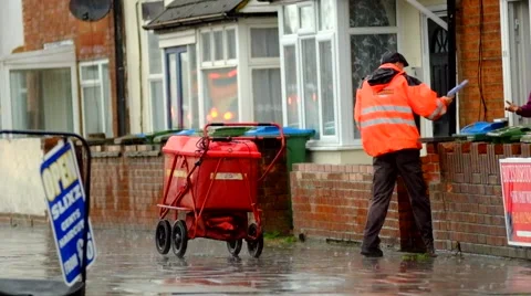 Postman delivering letters in heavy rain Stock-Footage 44019465