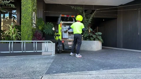 Postman delivering mails and parcels in the latest battery-operated Stockbeeldmateriaal 225851096