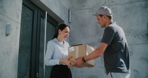 Postman Delivering Parcel Box for Recipient. Businesswoman Signing POD on Tablet Stock Footage 312387723