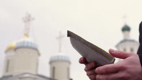 Postman gives closed envelope to young orthodox priest Stock Footage 243297573