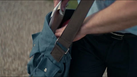 Postman taking some letters out of the bag Stock Footage 263972757