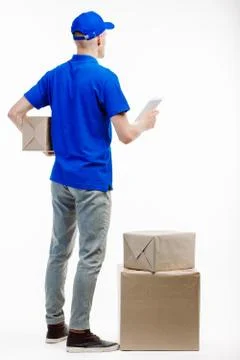 Postman in uniform not facing the camera. Stock Photos