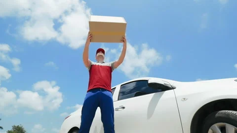 Postman in uniform twists and throws a box. Stock Footage 89354605