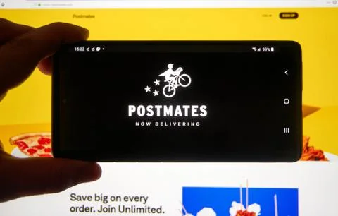 Postmates application and logo on a cell phone. 写真素材