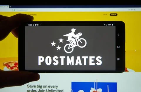 Postmates application and logo on a cell phone. Фото