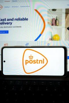 Postnl logo on mobile phone displaying postal services Fotos de archivo