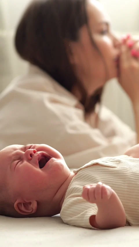 Postpartum depression concept with a tired and stressed mother ignoring her Stock Footage 341430000