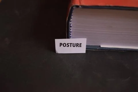 Posture Paper Tab Inserted in Book Pages Symbolizing Fitness and Stability Фото