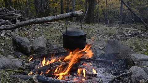 Pot above bonfire Stock Footage 104797471