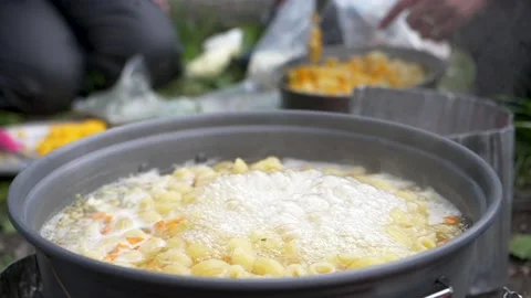 Pot boiling on camping stove Stock Footage 146239425