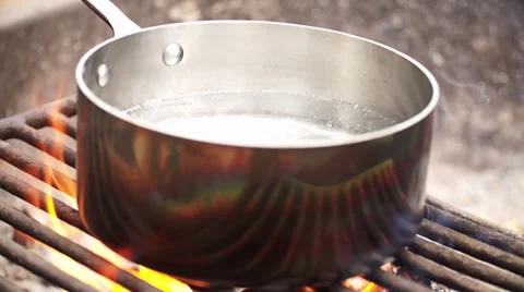 Pot Boiling Water Over A Fire Pit Stock Footage 30461726
