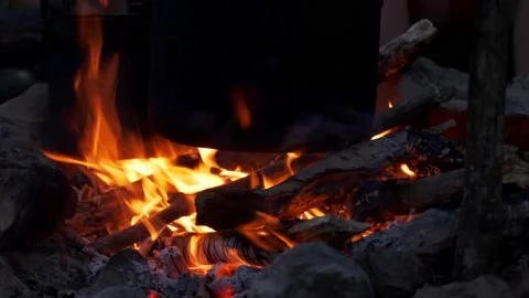 A pot on a campfire at dusk Stock Footage 138076156