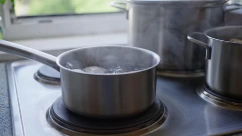 A pot containing eggs is boiling in water, The process of cooking preparation Stock Footage 281656389