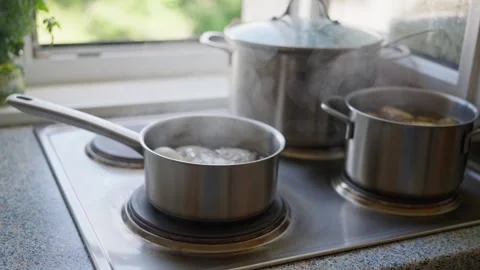 A pot containing eggs is boiling in water on the stove, the process of cooking Stock Footage 282588619