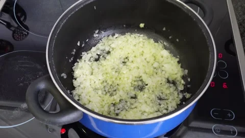 Pot with diced onions being cooked Stock Footage 296488232