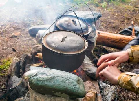 The pot on the fire in the campaign. Stock Photos