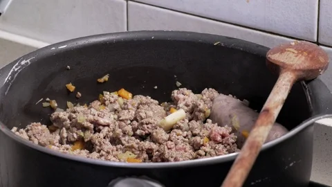 Pot on the fire with ground meat and sausages Stock-Footage 72942776