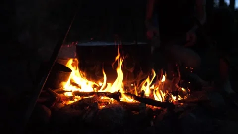 A pot on a fire at night while camping Stock Footage 249267336
