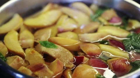 Pot with freshly brewed compote. Delicious fruit compote. Compote of peaches Stock Footage 256027042