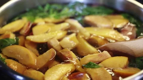 Pot with freshly brewed compote. Delicious fruit compote. Compote of peaches Stock Footage 256027053
