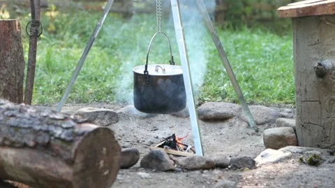 The pot is hanging over the fire, no people 4K Stock Footage 194674050