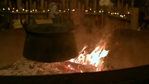 Pot Heating Over a Wood Fire During Christmas Видео 345405862