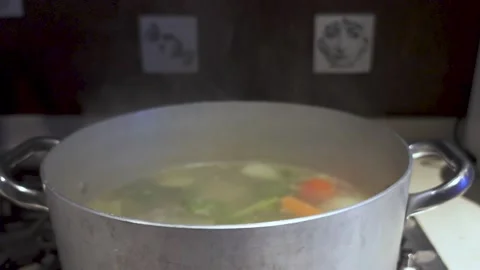 Pot with a hot vegetable soup being cooked and steam. 스톡 동영상 232328118